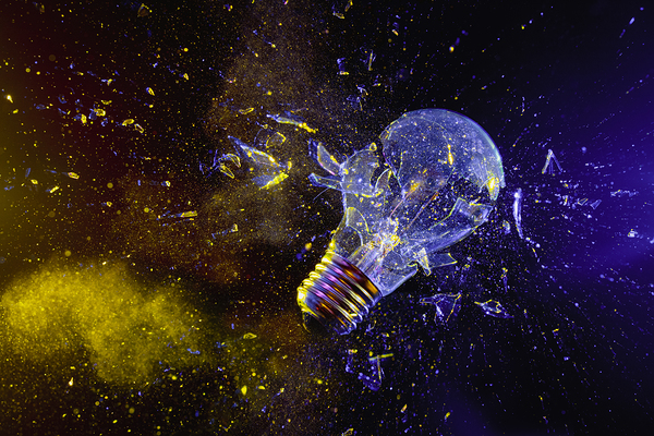 broken light bulb on black.