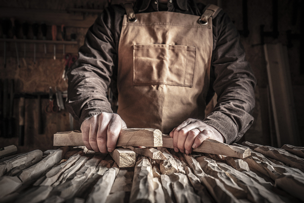 carved wood in hands