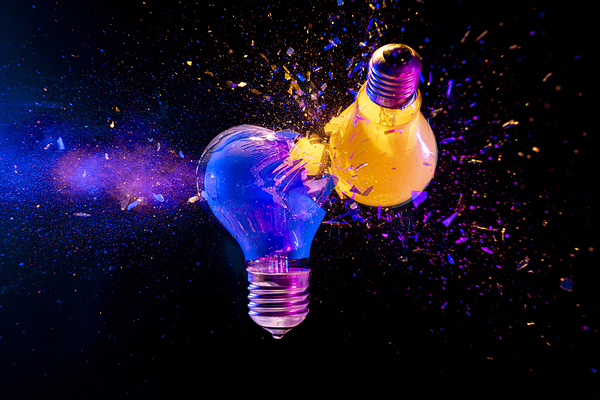 Two colorful light bulbs exploding in a cloud of shards Print