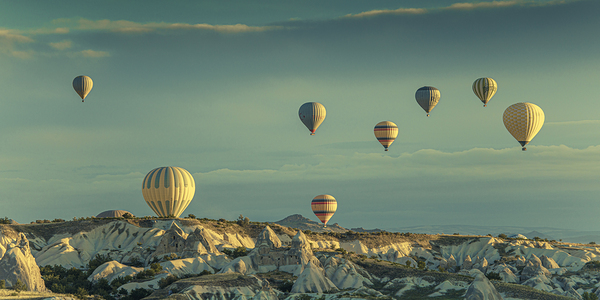 hot air balloons fly over goreme at dawn.