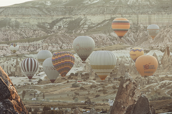  hot air balloons fly over the city of goreme at sunrise