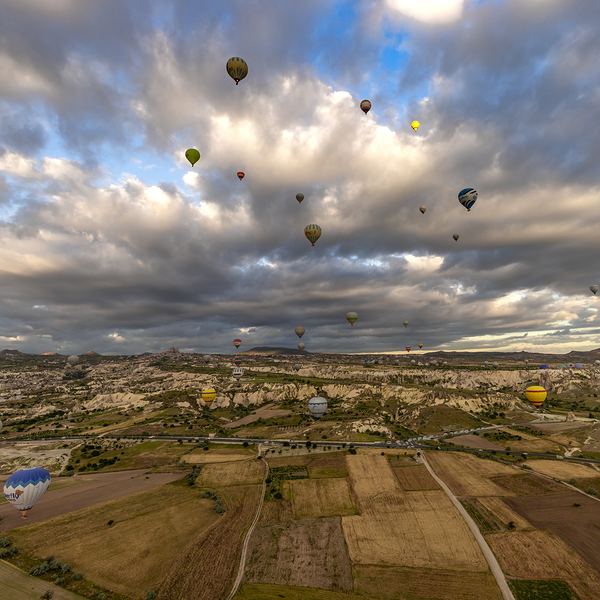 colorful hot air balloons fly at sunrise near goreme