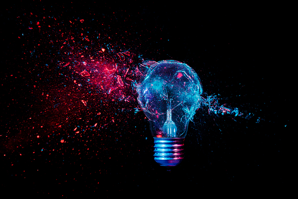 glass explosion of a filament light bulb on black.  Print