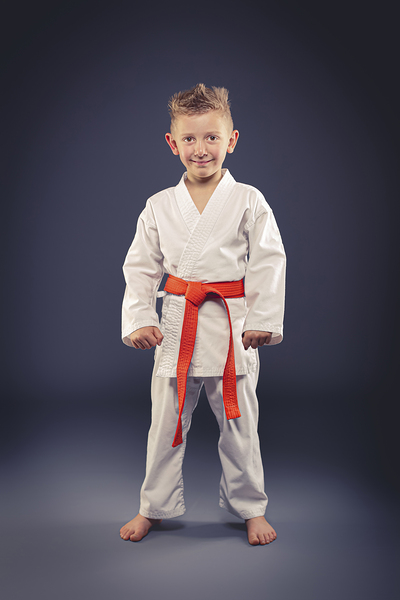 portrait of a smiling child with kimono practicing martial arts Print
