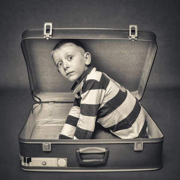 child with astonished expression in a suitcase Print