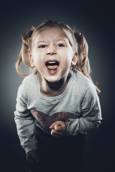 caucasian girl with pigtails angry expression 