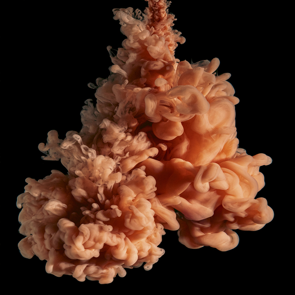 cloud of orange ink on black.  Print