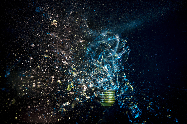 explosion of a glass bulb on black. High speed photography.  Print