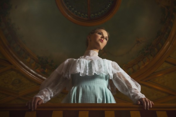 Young girl standing under a classical artwork of the cathedral ceiling Print