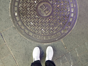 Manhole cover on sidewalk street in Seoul South Korea