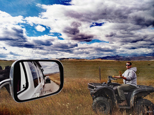Canadian cowboy herder riding atv Alberta
