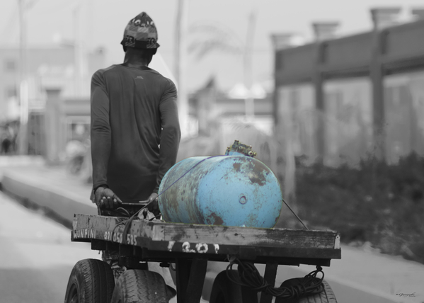 Sun-soaked Grit: Capturing the Determination of a Street Worker by Ganyobiphotos