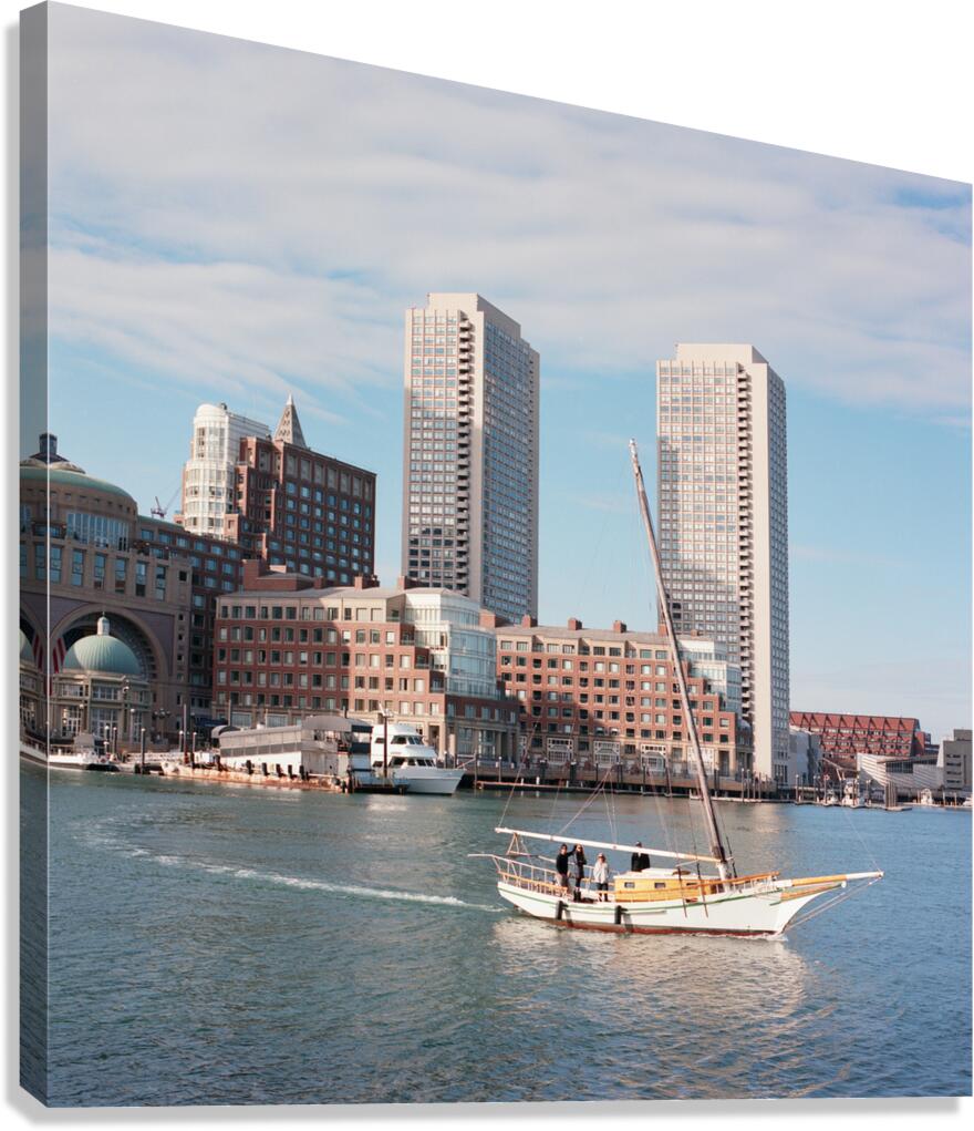 Sailboat floating by harbour with city skyline Canvas Print