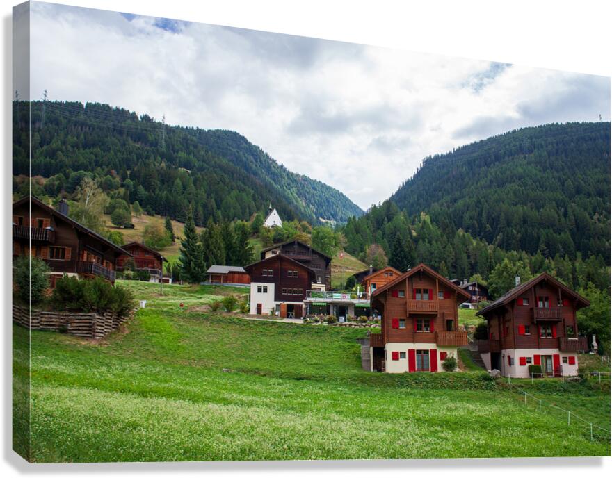 Charming houses dotting the Swiss Alps in Switzerland. Canvas Print