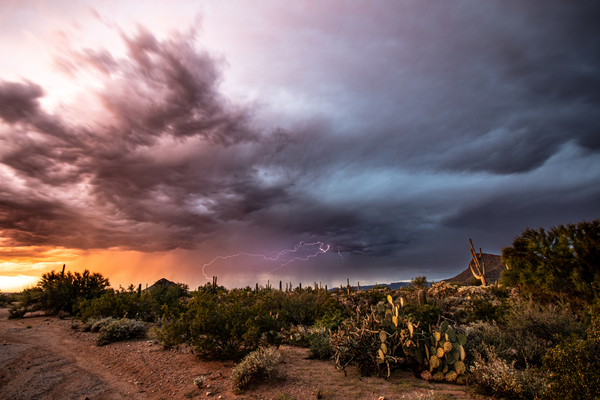 Lightning Strikes Against colored sky by James Rupersburg