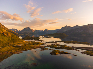 sunset view of Lofoten Norway from above with high mountains fjord of Selfjord colorful sky.