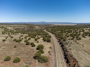 Road 66 in northern Arizona towards Flagstaff. Coconino county and forest in the distance and Humphreys peak in the horizon