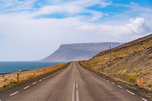 Road in the high arctic nature of Iceland Westfjords. High cliffs open nature.
