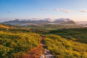 View of Lofoten mountains and nature from a high mountain top from Justadtinden towards Leknes. Summer sun