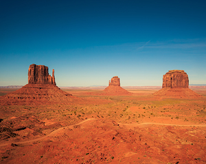 Monument valley landscape Utah USA clear blue sky and long shadows. The three famous mittens