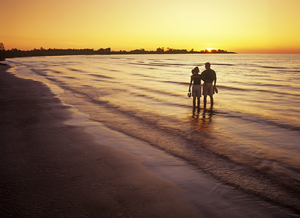 Couple Along Beach at Sunset