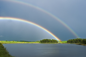 prairie slough with farmland and rainbow