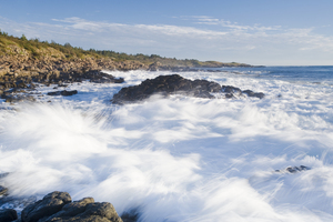 waves over basalt rock cliffs