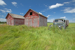 old farm truck beside grain bin