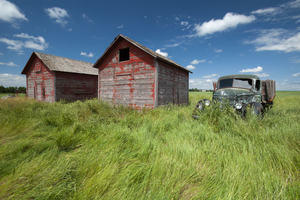 old farm truck beside grain bin