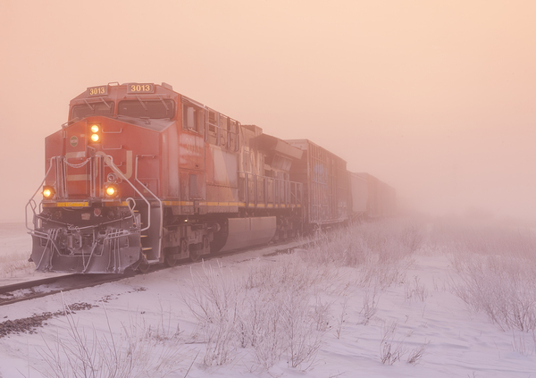 a locomotive pulling general freight  in winter by Dave Reede Photohgraphy