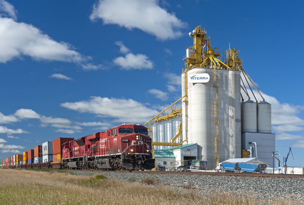 a train carrying shipping containers passes an inland grain terminal by Dave Reede Photohgraphy