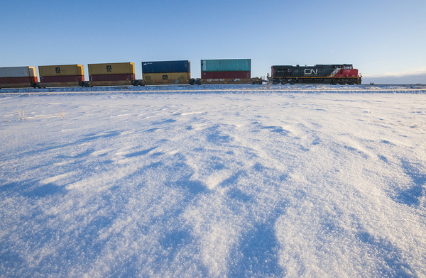 Long Haul Over a Snowy Landscape by Dave Reede Photohgraphy