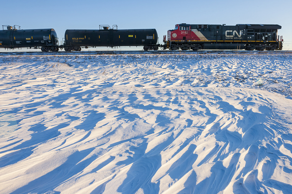 Locomotive Pulling Tanker Cars Passing Snow Drift Patterns by Dave Reede Photohgraphy