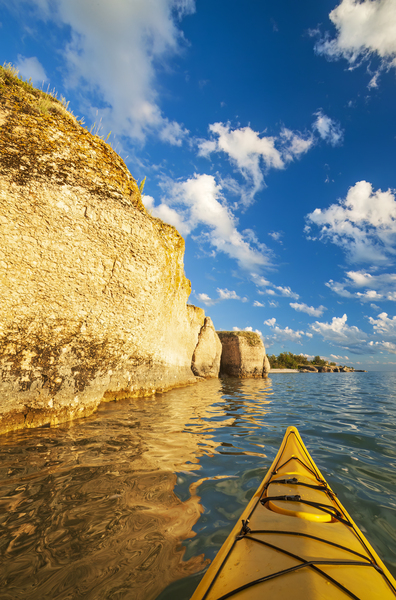 kayaking along limestone cliffs Print