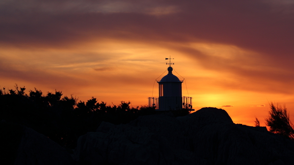 Lighthouse sunset by Doimo Antonini