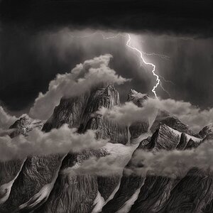 High mountains shrouded in clouds.You can see the peaks.Dark Sky.