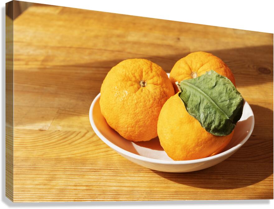 Fresh oranges in plate Canvas Print