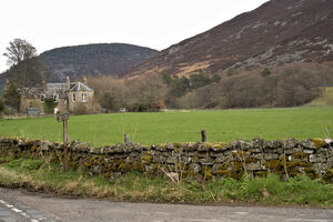 Farm home surrounded by lush green meadow and a rock fence covered with moss   DSC5171  1