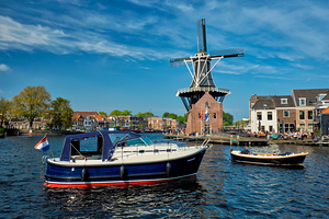 Harlem landmark windmill De Adriaan and boat on Spaarne river.