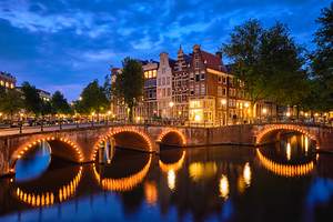 Amsterdam canal bridge and medieval houses in the evening