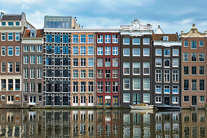 Amsterdam canal Damrak with houses Netherlands