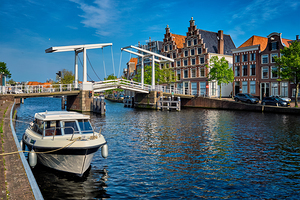 Spaarne river with boat and Gravestenenbrug bridge in Haarlem N