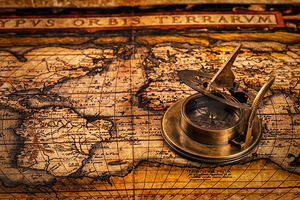 Old vintage compass on ancient map