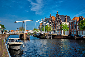 Spaarne river with boat and Gravestenenbrug bridge in Haarlem N