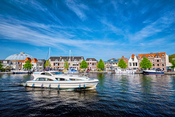 Boats and houses on Spaarne river. Haarlem Netherlands by Dmitry Rukhlenko