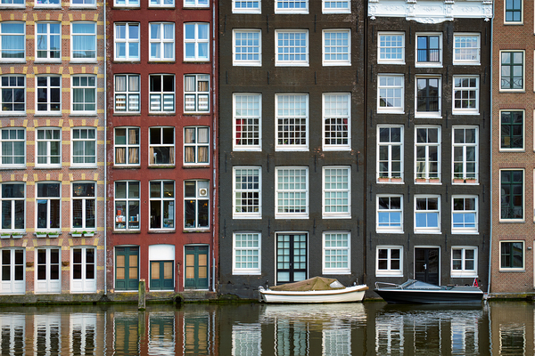 Amsterdam canal Damrak with houses Netherlands by Dmitry Rukhlenko