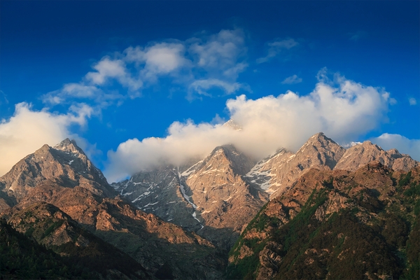 Himalayas summits in clouds on sunset by Dmitry Rukhlenko