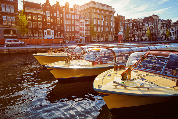 Amsterdam tourist boats in canal by Dmitry Rukhlenko