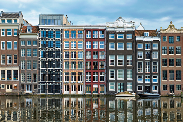 Amsterdam canal Damrak with houses Netherlands by Dmitry Rukhlenko