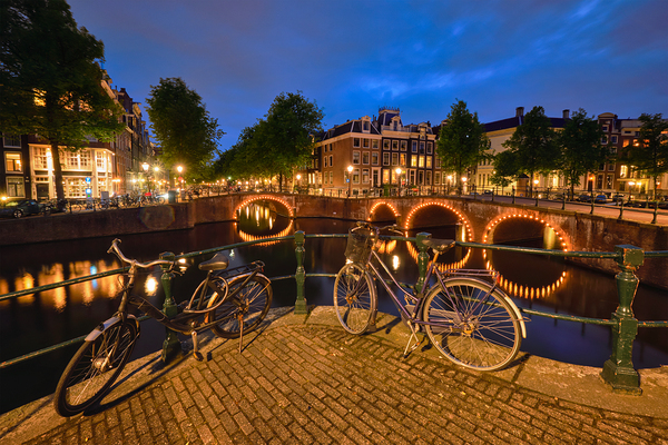 Amsterdam canal bridge and medieval houses in the evening by Dmitry Rukhlenko